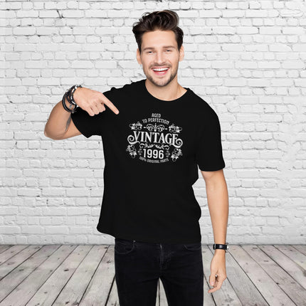 Man pointing at the Vintage 1996 Aged to Perfection print on his black 30th birthday t-shirt