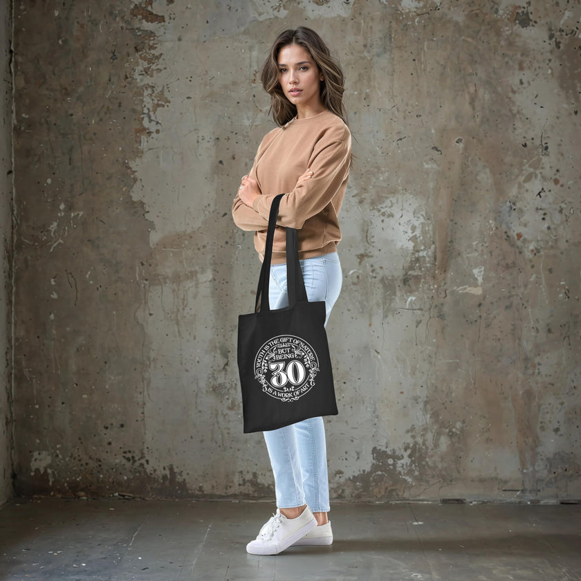 Being 30 is a Work of Art 30th birthday tote bag in black carried over the shoulder