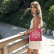 Woman holding the Vintage 1996 Aged to Perfection 30th birthday tote bag in raspberry pink