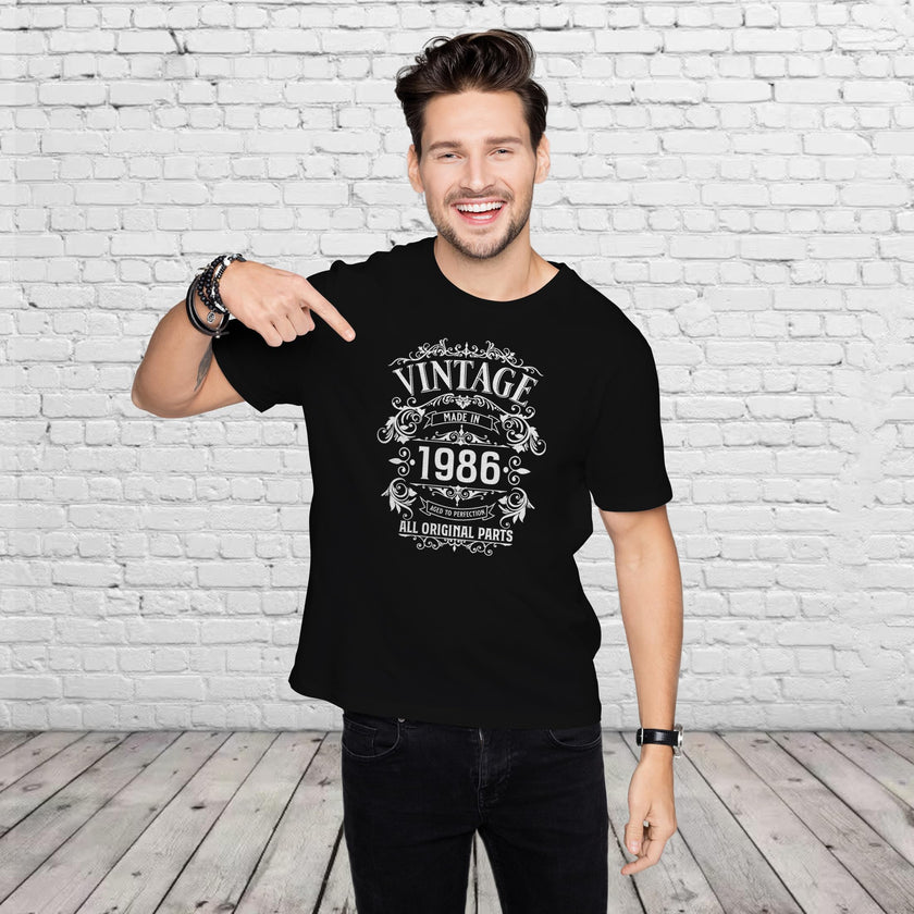 Man pointing at the Vintage 1986 All Original Parts print on his black 40th birthday t-shirt