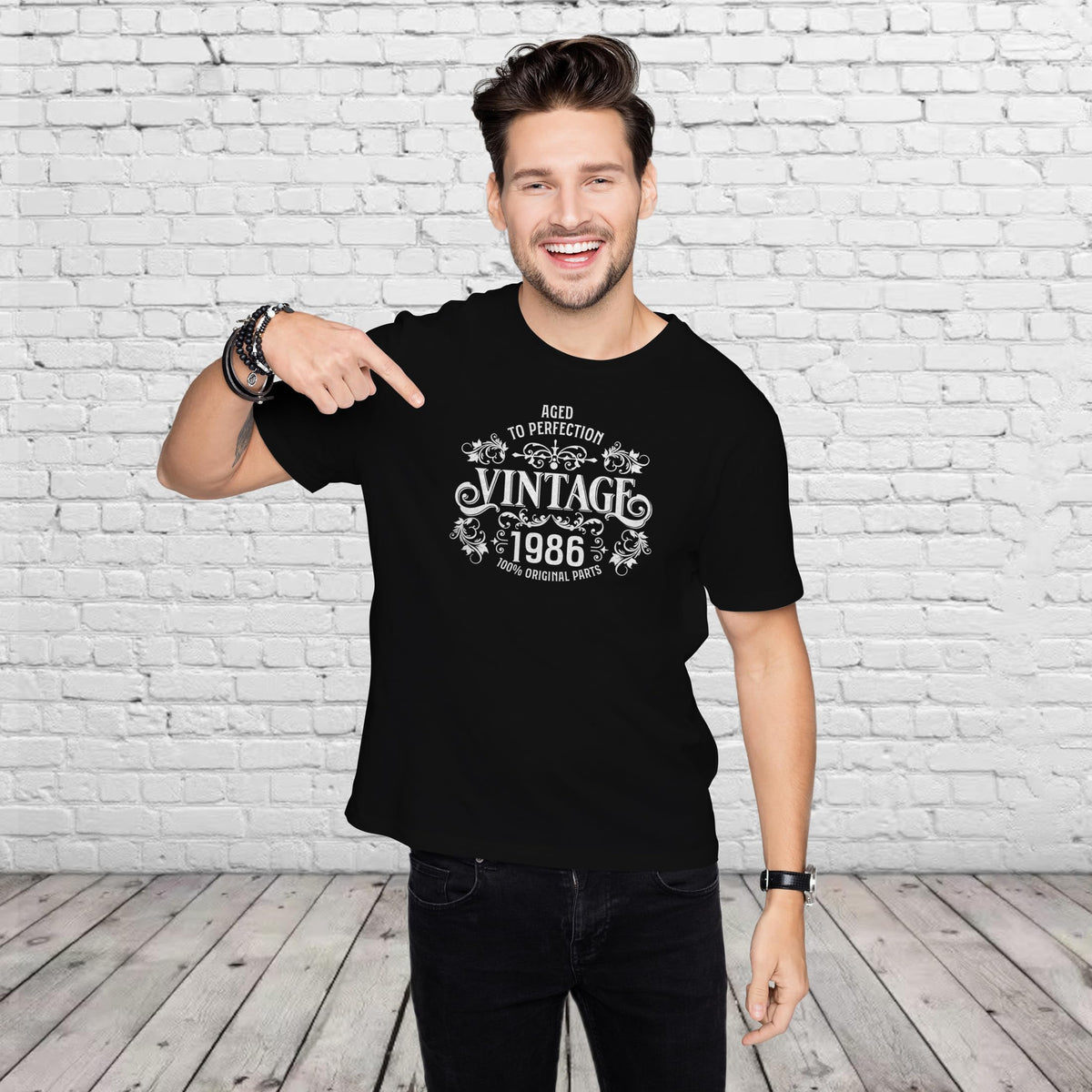 Man pointing at the Vintage 1986 Aged to Perfection print on his black 40th birthday t-shirt