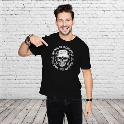 Man pointing at the Hitting 40 is Essential print on his black 40th birthday t-shirt