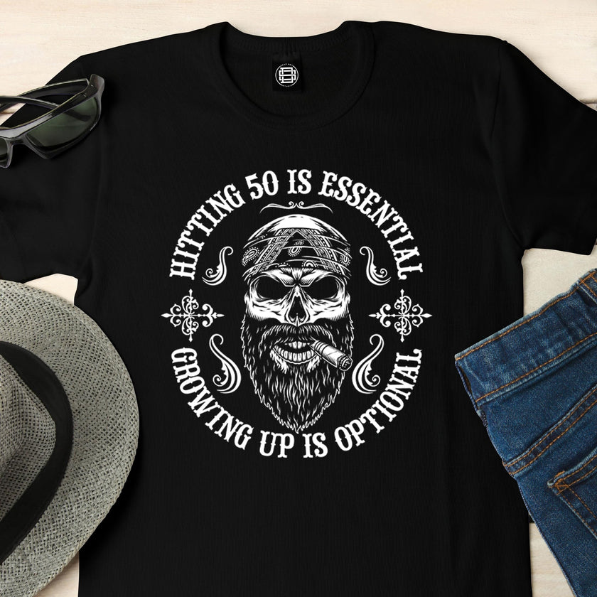 Close-up of the Hitting 50 is Essential print on a black 50th birthday t-shirt