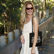 Vintage 1976 Aged to Perfection 50th birthday tote bag in black carried over the shoulder