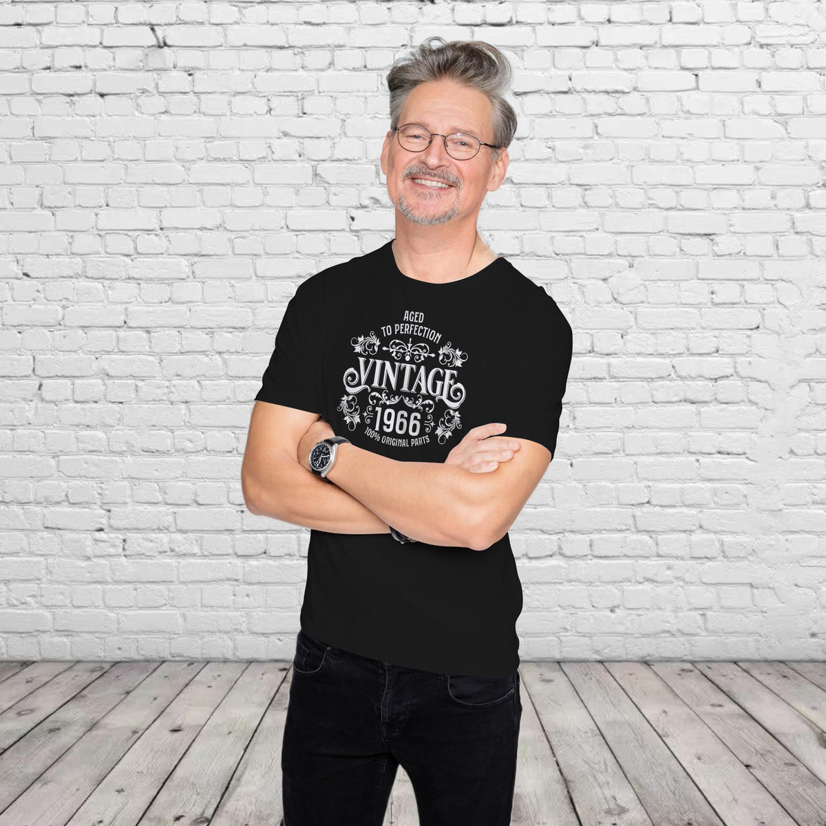 Smiling man in the black Vintage 1966 Aged to Perfection 60th birthday t-shirt