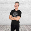 Smiling man in the black Vintage 1966 Aged to Perfection 60th birthday t-shirt