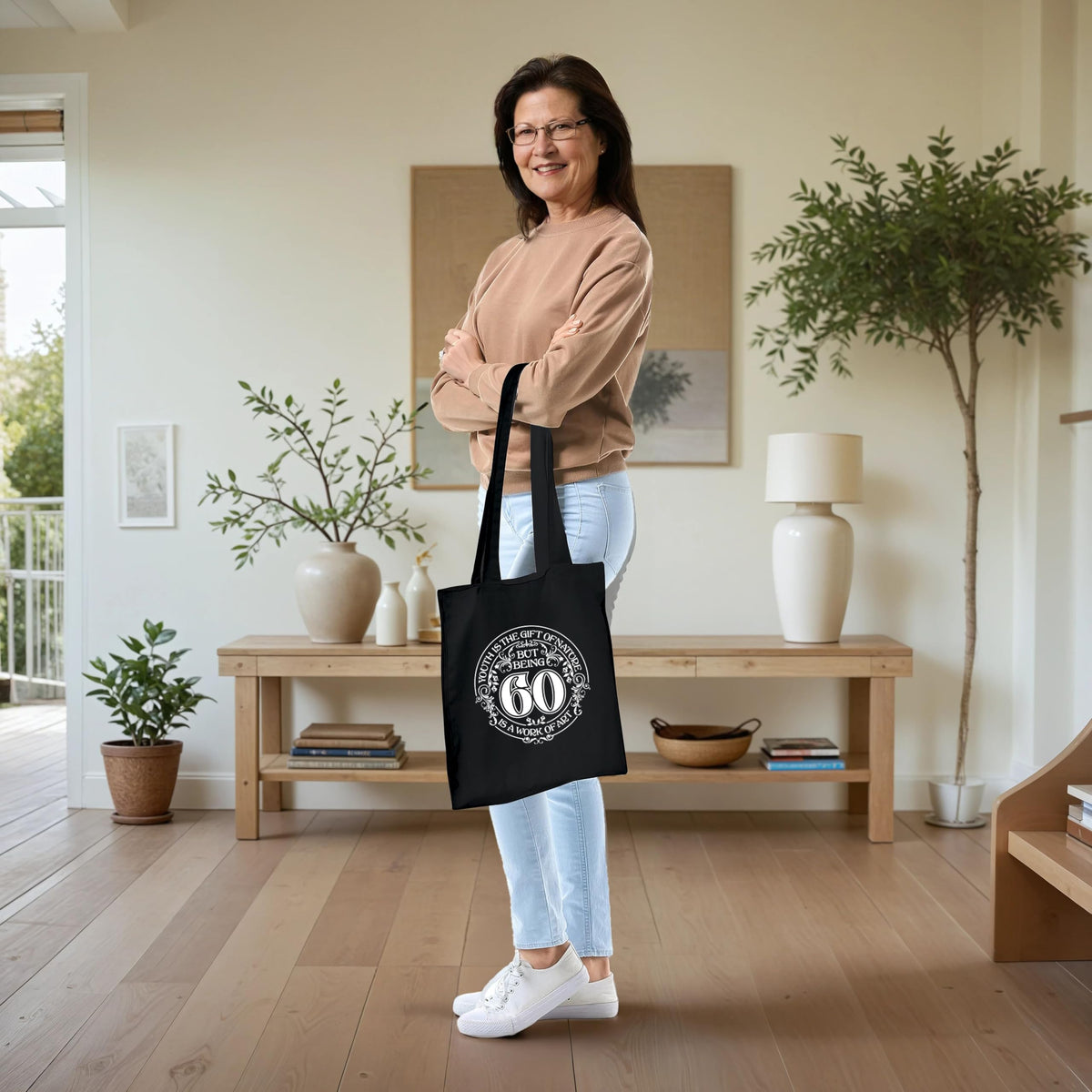 Being 60 is a Work of Art 60th birthday tote bag in black carried over the shoulder
