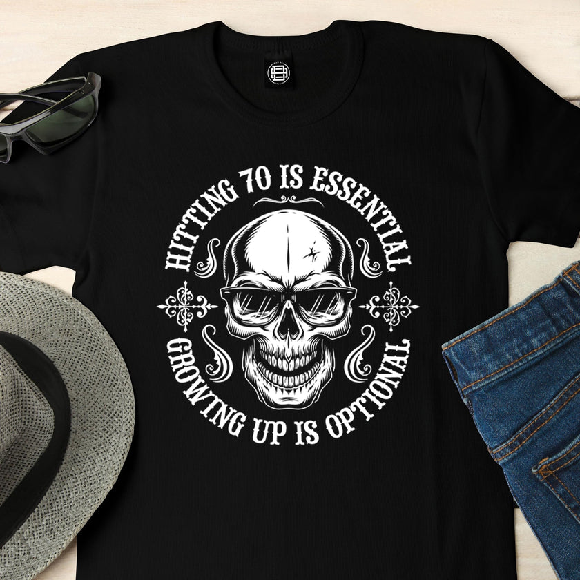 Close-up of the Hitting 70 is Essential print on a black 70th birthday t-shirt