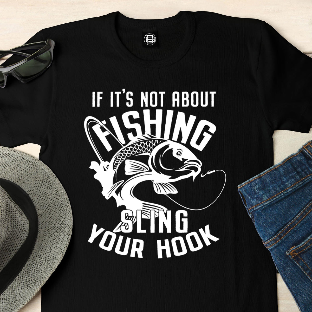 Close-up of the Sling Your Hook print on a black fishing t-shirt
