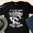 Close-up of the Sling Your Hook print on a black fishing t-shirt
