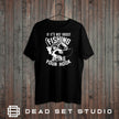 Sling Your Hook fishing t-shirt in black on a rustic wood background