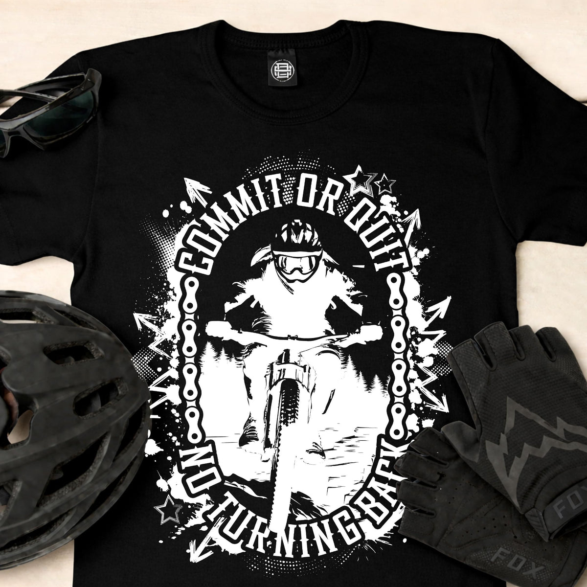 Close-up of the Commit or Quit print with a bike helmet and gloves