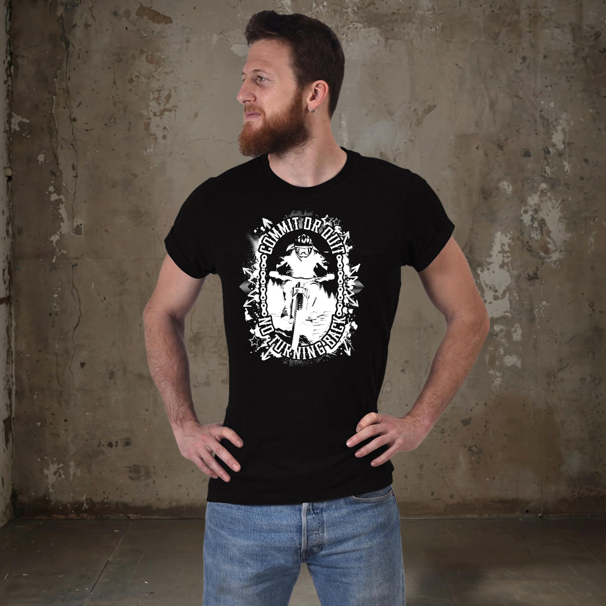 Man in the black Commit or Quit mountain bike t-shirt looking to the side