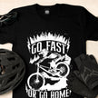 Close-up of the Go Fast or Go Home print with a bike helmet and gloves