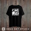 A Little Dirt Never Hurt off road 4x4 t-shirt in black on a rustic wood background