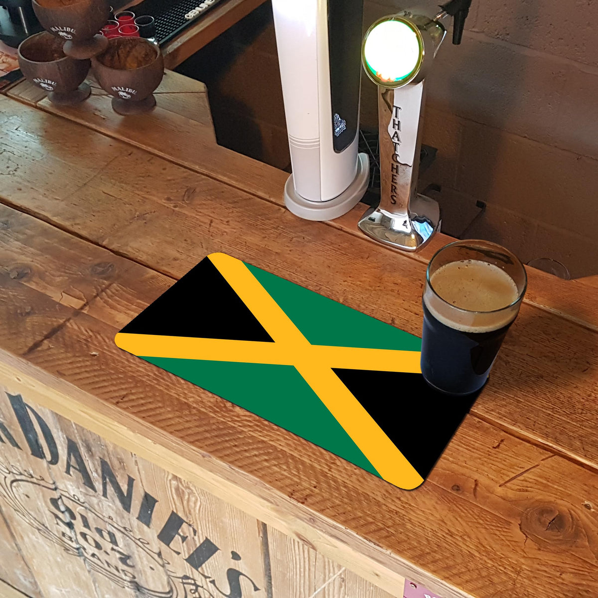 Jamaican flag bar runner mat on a wooden bar top