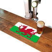 Welsh flag rubber bar runner mat on a home bar counter